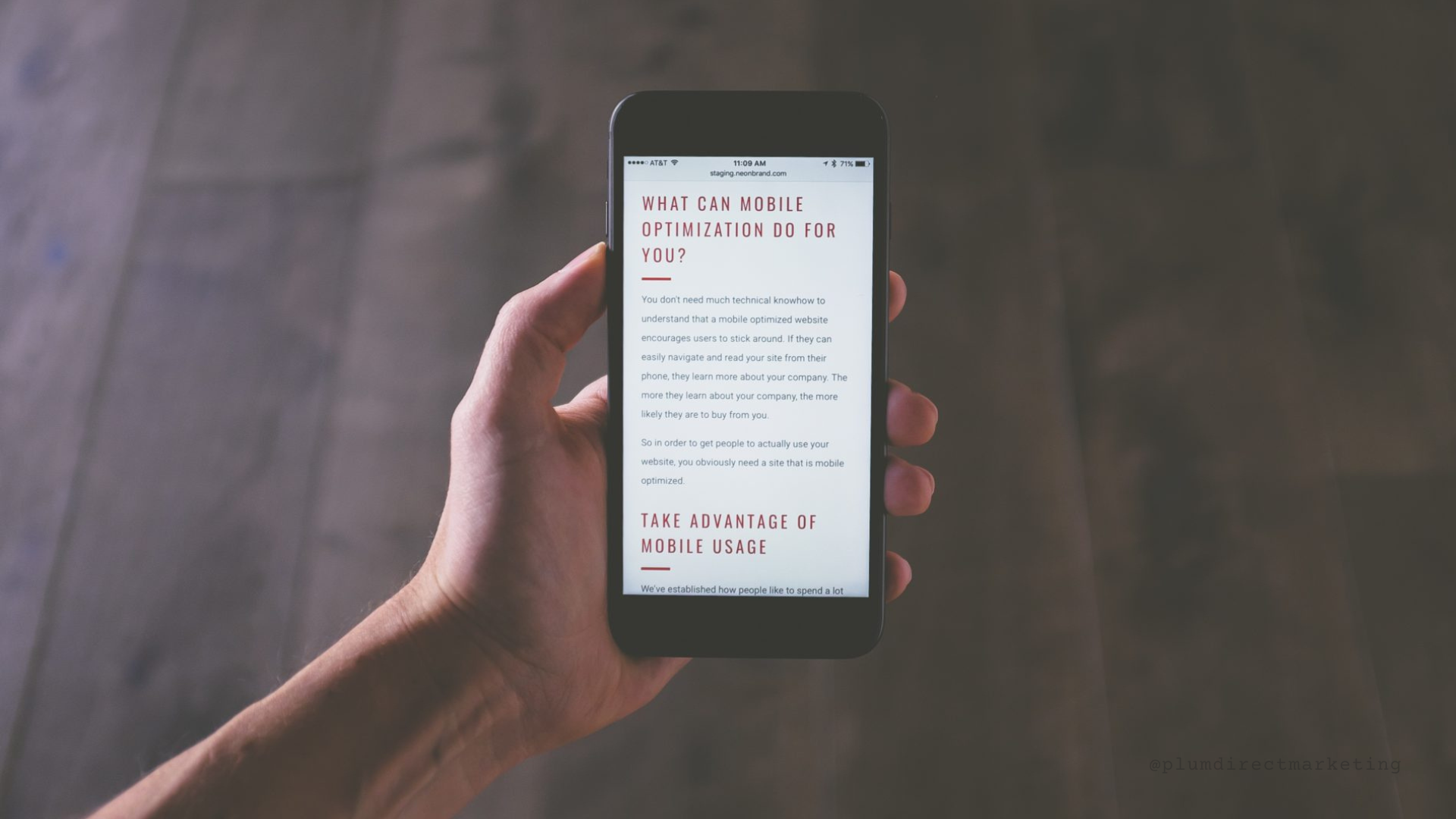 Person holding smartphone displaying a responsive website with mobile-optimized content on screen.