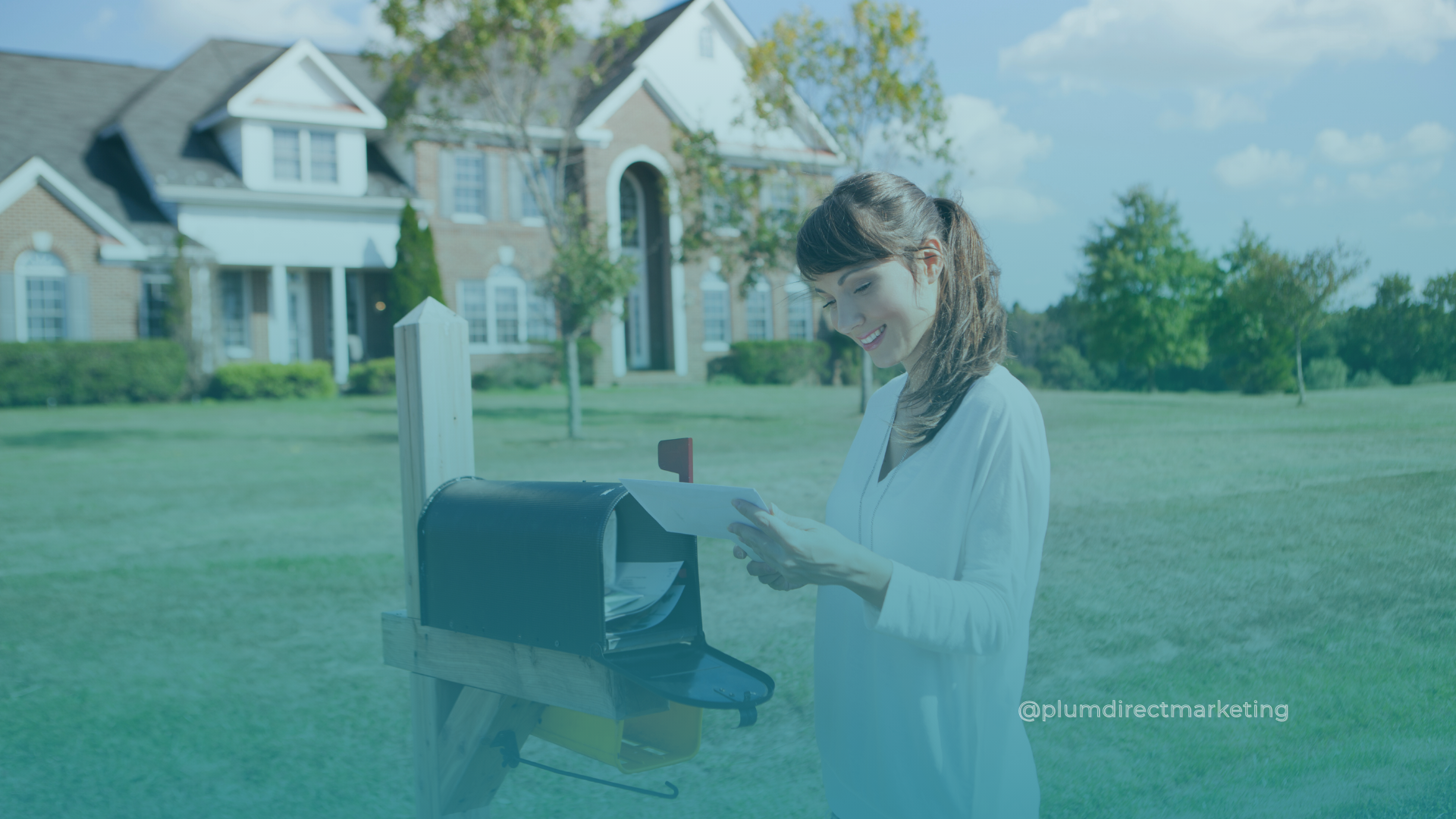 Young woman smiling while receiving direct mail flyers from a mailbox outside her home