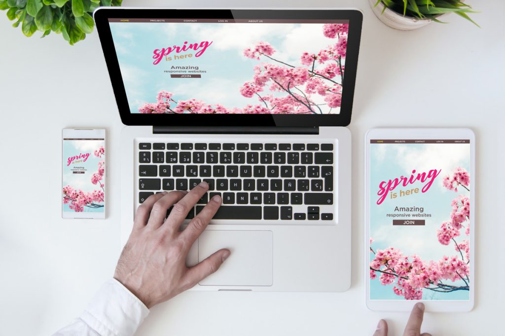 Mockup of spring-themed landing page displayed on phone, tablet, and laptop with matching postcard branding