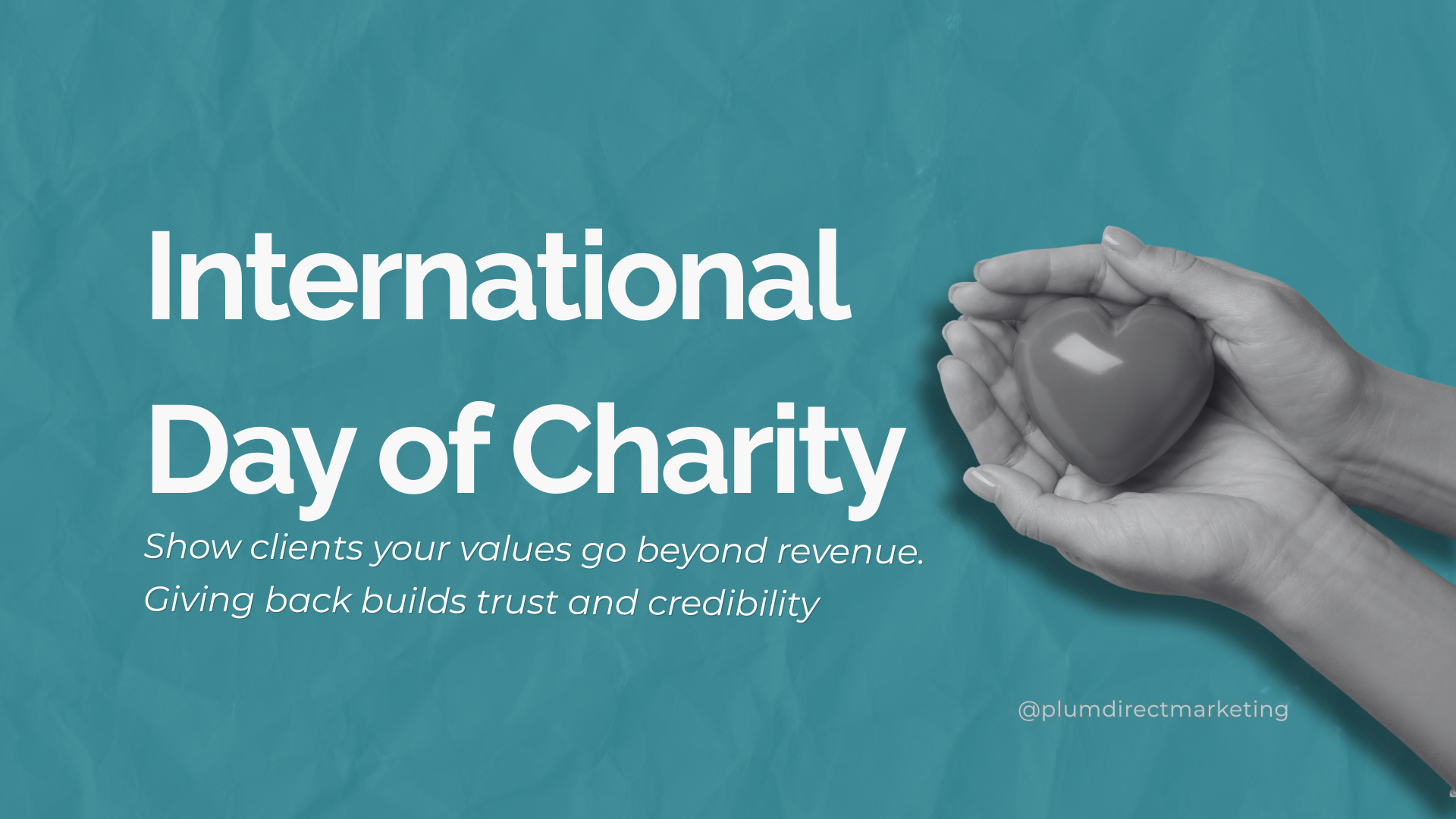 International Day of Charity featured image for Plum Direct Marketing — hands holding a heart symbol to represent trust, credibility, and charity marketing strategy for businesses.