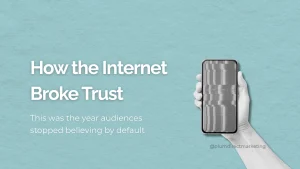 Hand holding a smartphone with a glitching screen, symbolizing the collapse of digital trust in 2025.